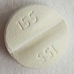 Белая таблетка с надписью 155 препарата Дюфастон картинка